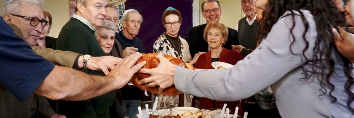 congregants blessing challah