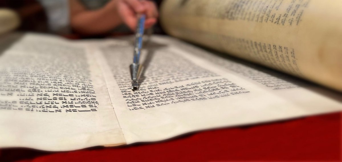 metal yad pointing at Torah text