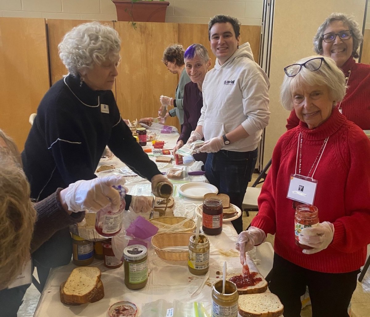 Congregants preparing sandwiches from contributed ingredients to go to local neighbors in need, through nonprofit Grassroots Grocery